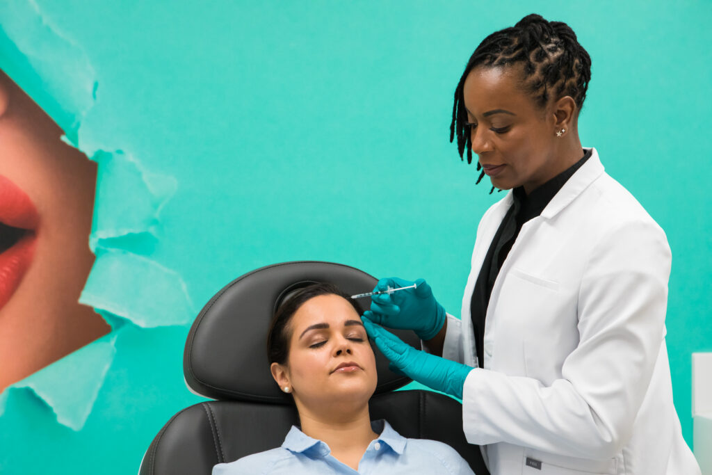 Provider administering a Botox or Dysport injection to a patient's cheek